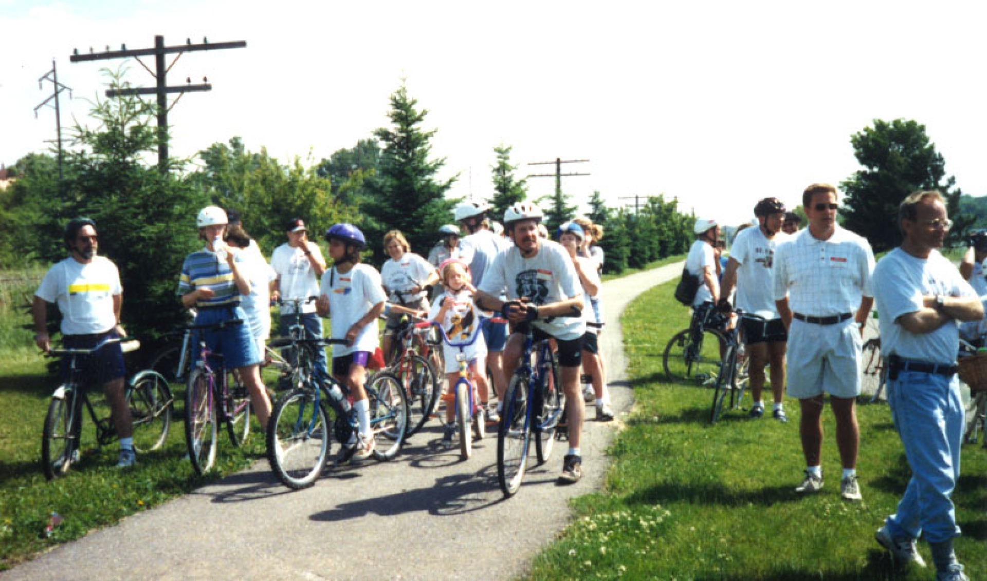 A group of people, some with bikes, on part of the Mill Towns State Trail.