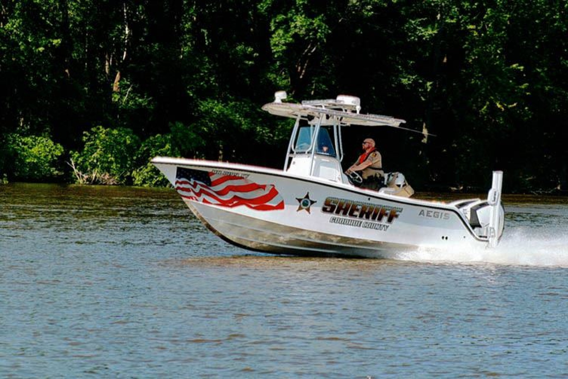 An officer patrolling the county waterway on their water patrol vehicle.